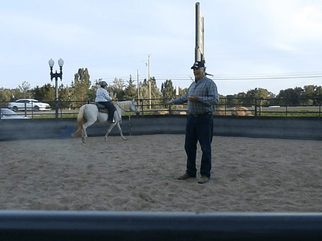 A rider circles the round pen during the service